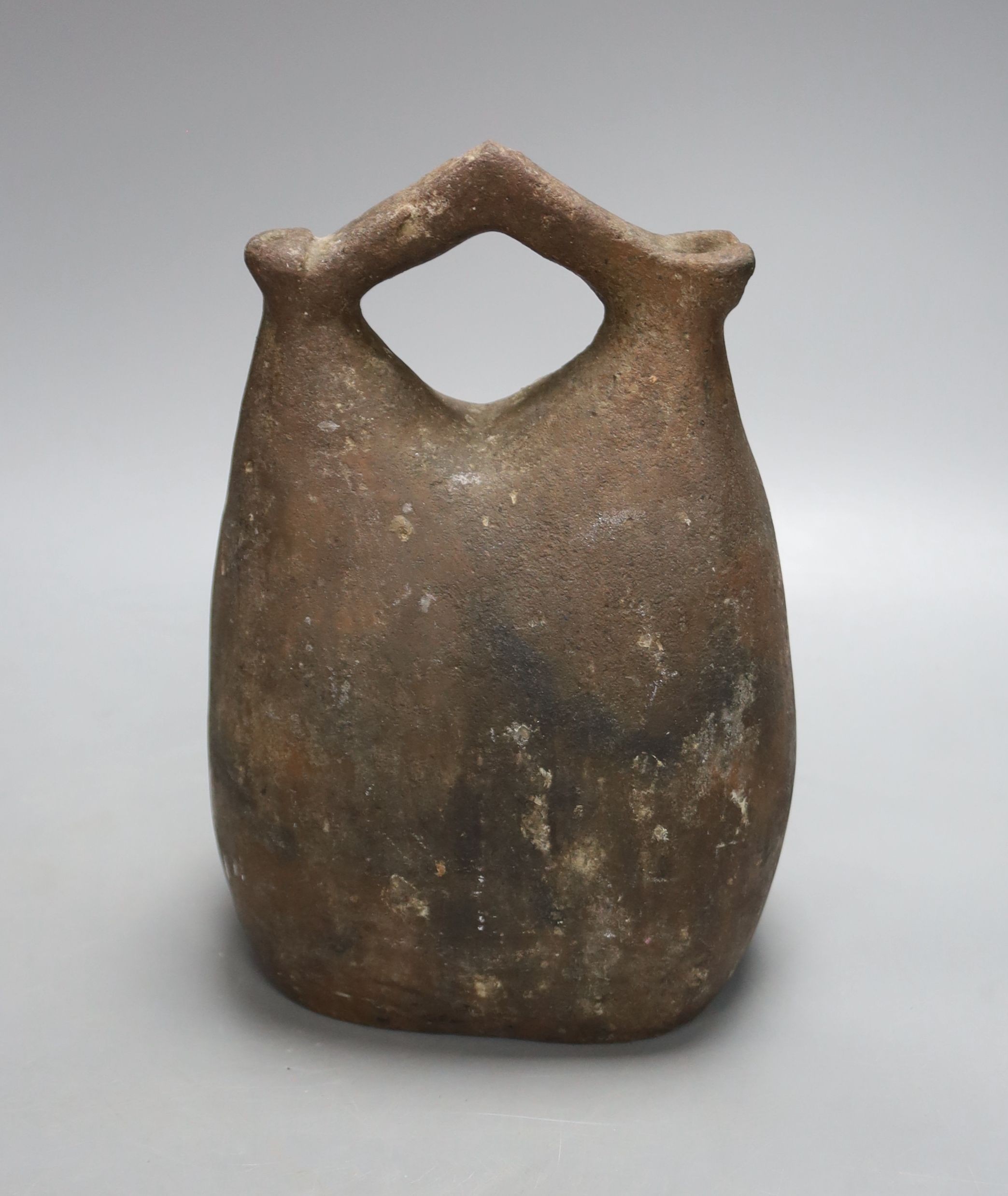 An Egyptian pottery flask, 23 cms high